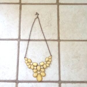 Brand unknown it is a small yellow white and bronze